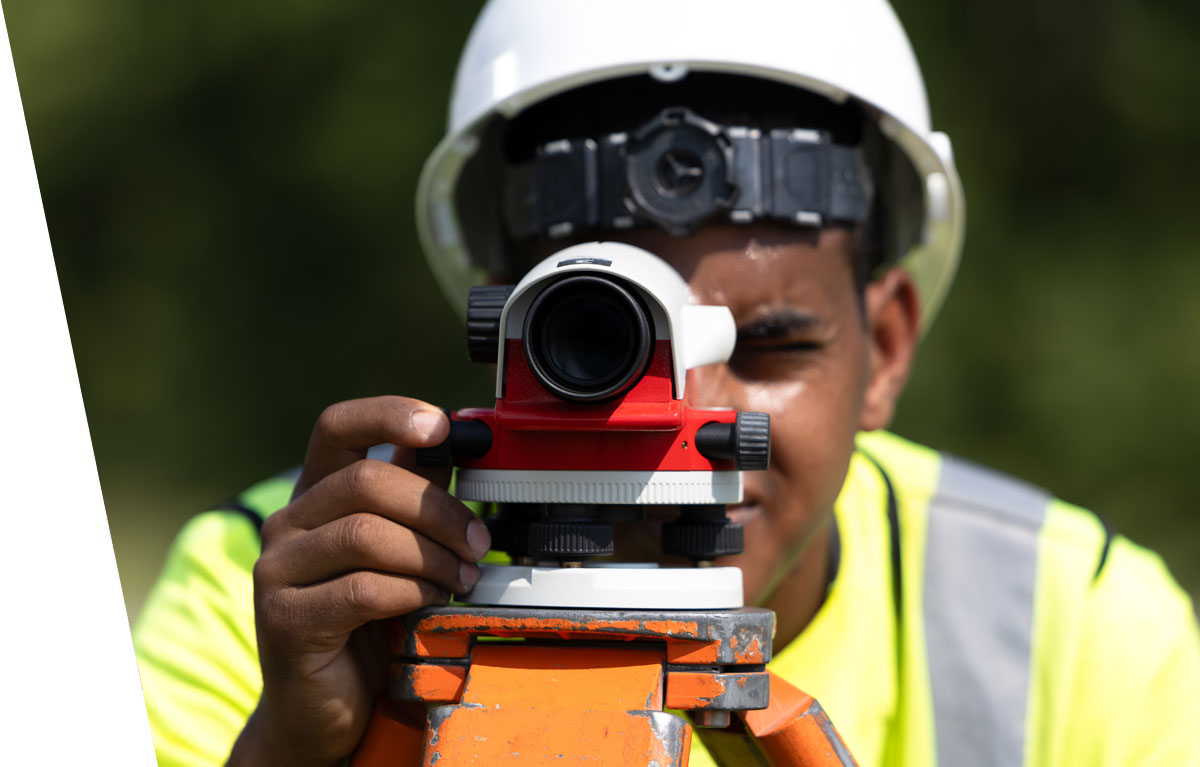 employee using surveying equipment